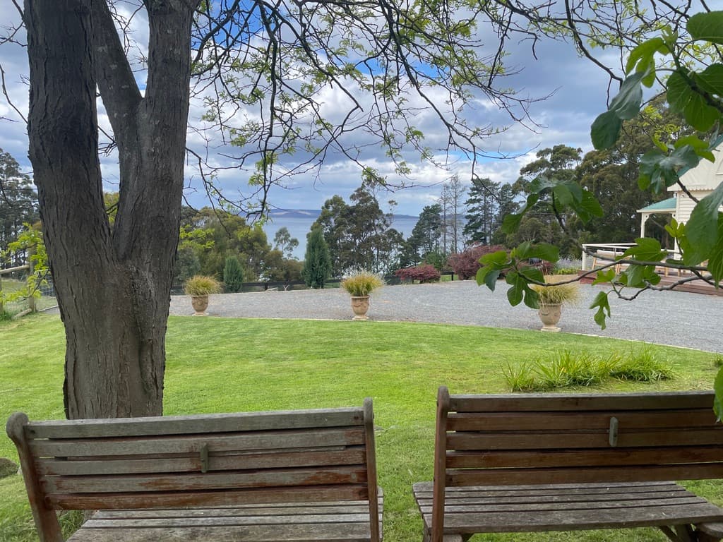 Garden benches with views across the lawn to D'Entrecasteaux Channel — The Cottage at Flowerpot, Southern Tasmania