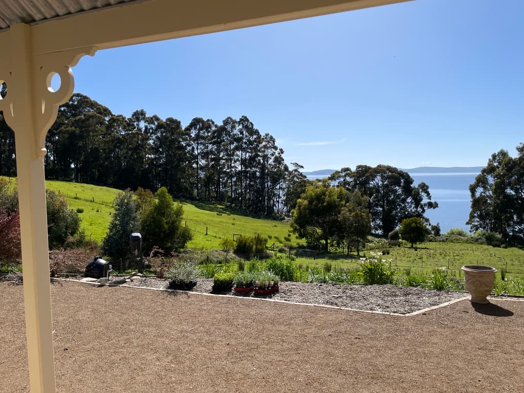 View from the verandah across green hills to D'Entrecasteaux Channel — The Cottage at Flowerpot, Southern Tasmania