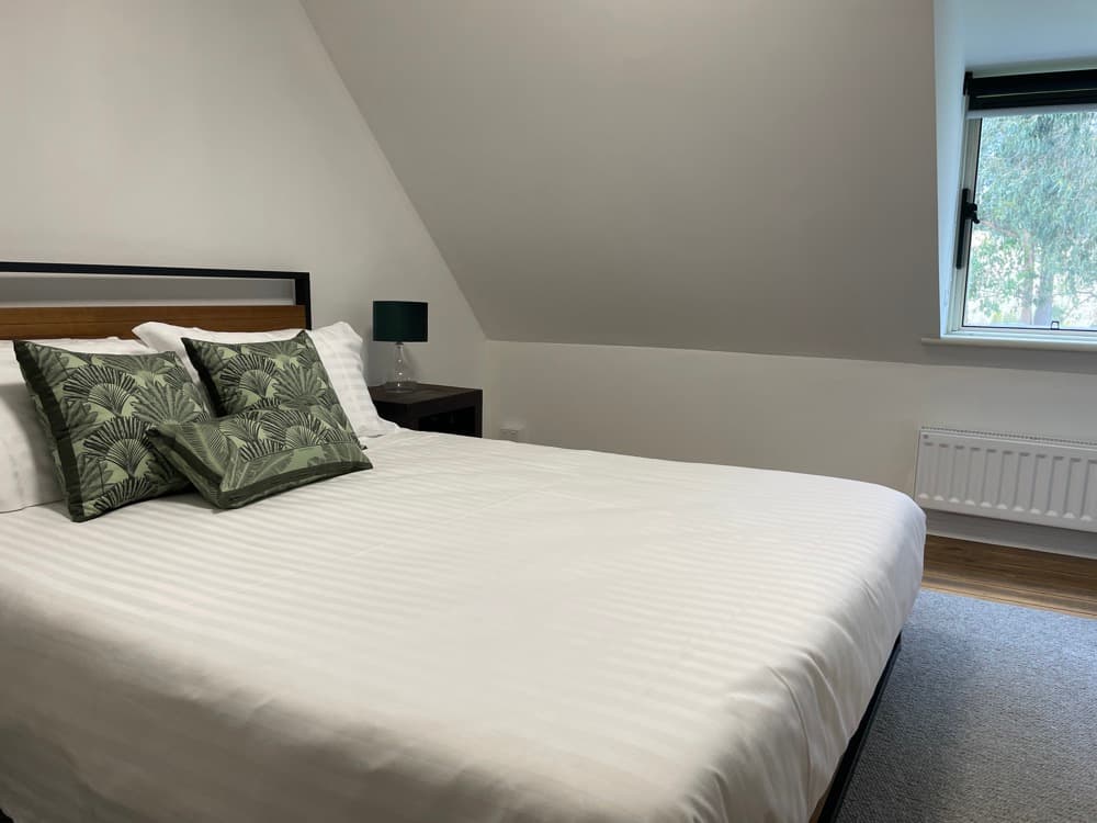 Southern loft queen bedroom with green views — The Cottage at Flowerpot, Southern Tasmania