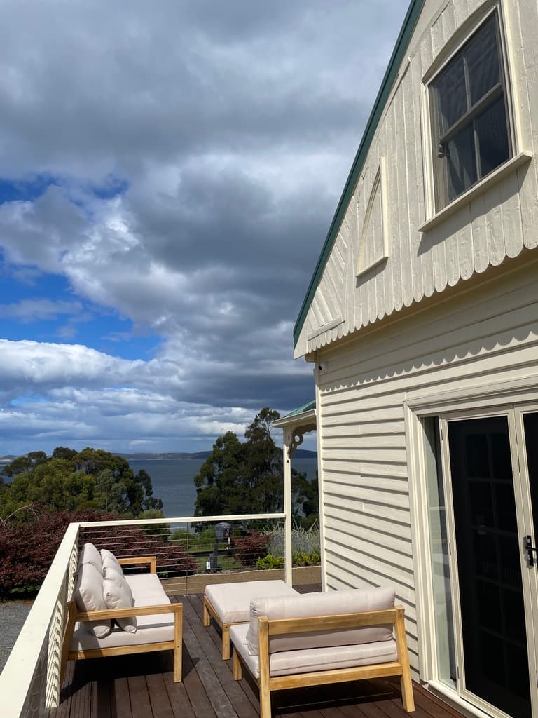 Timber deck with lounge seating and channel views — The Cottage at Flowerpot, Southern Tasmania
