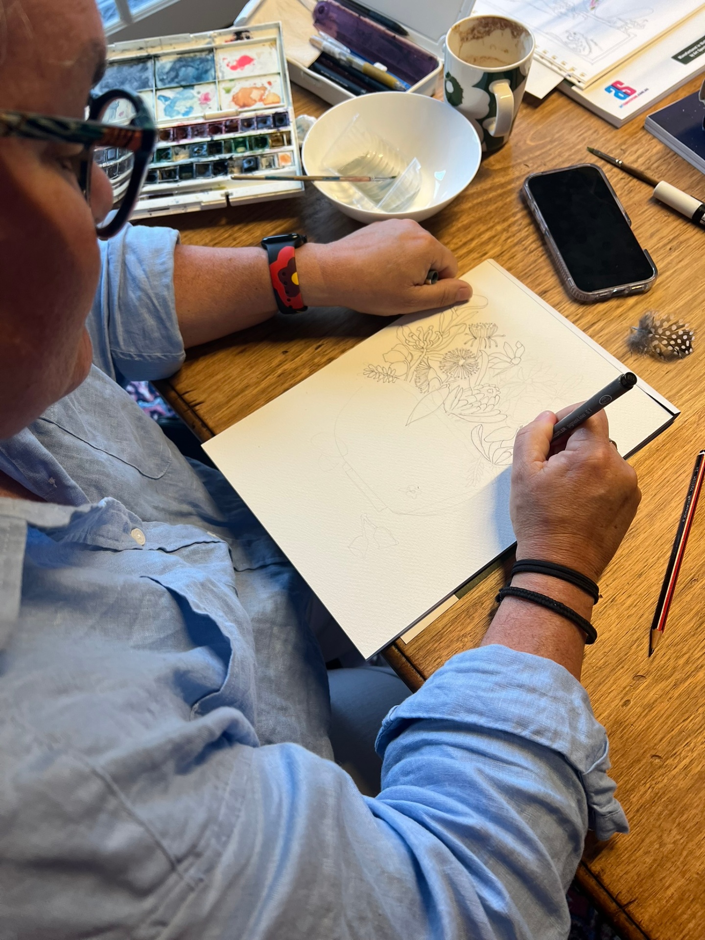 Artist drawing detailed botanical pencil illustrations